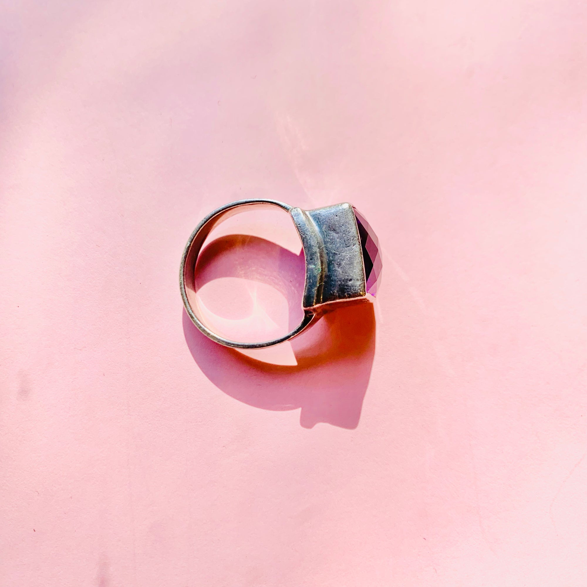 Antique sterling silver ring with purple glass paste solitaire stone