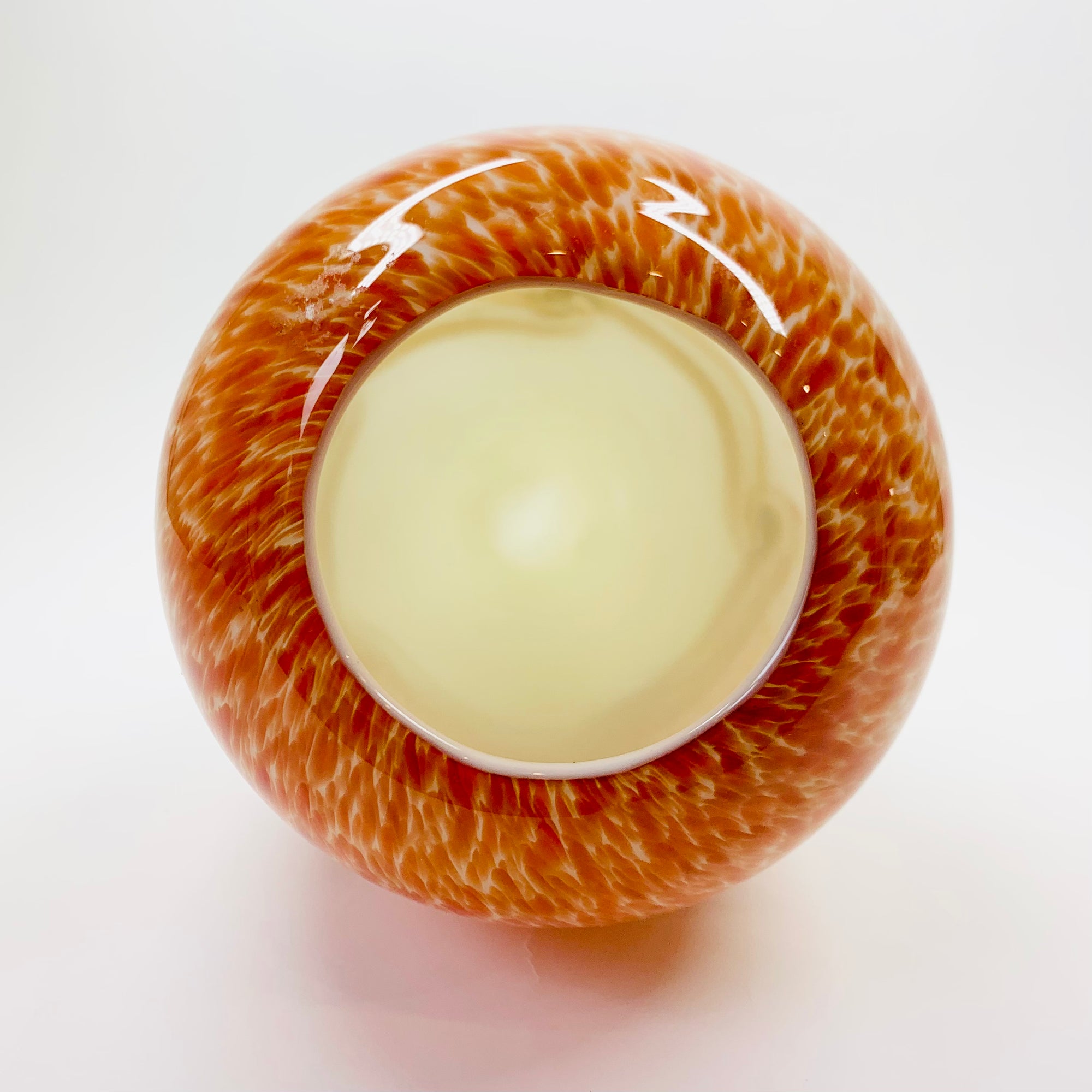 Vintage hand made orange cased art glass vase with abstract pattern