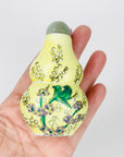 Antique Chinese hand painted yellow porcelain snuff bottle with jade stopper