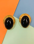 1960s brass clip on earrings with black bead center stone and filigree