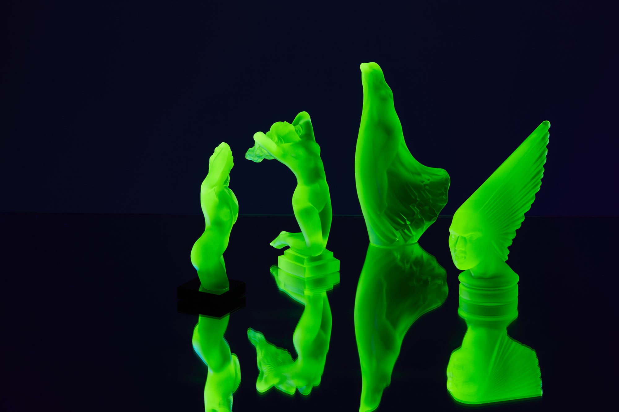 Art Deco reproduction of Lalique Nude with star bangle cape figurine in uranium glass