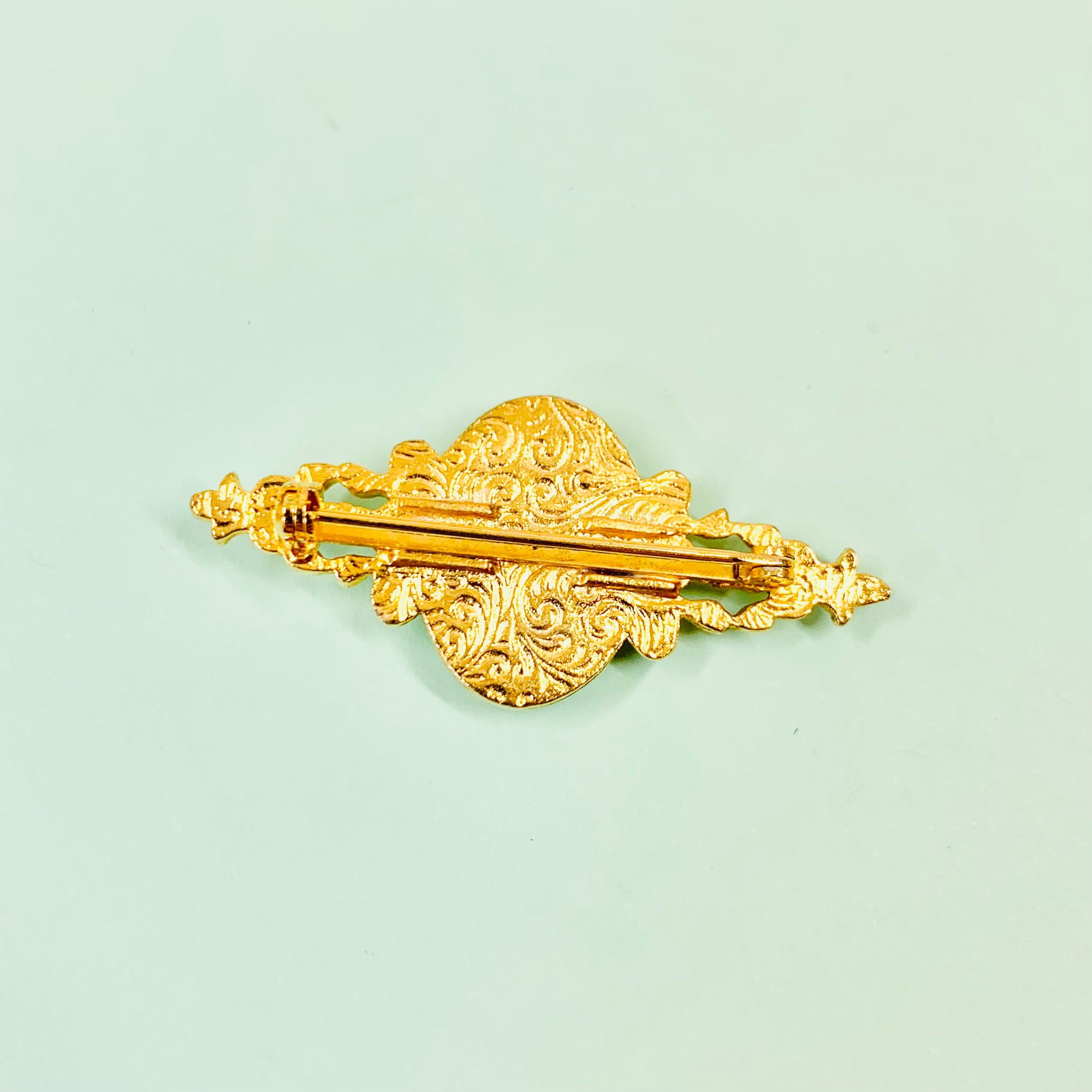 Antique gilt metal costume brooch with floral resin