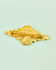 Antique gilt metal costume brooch with floral resin