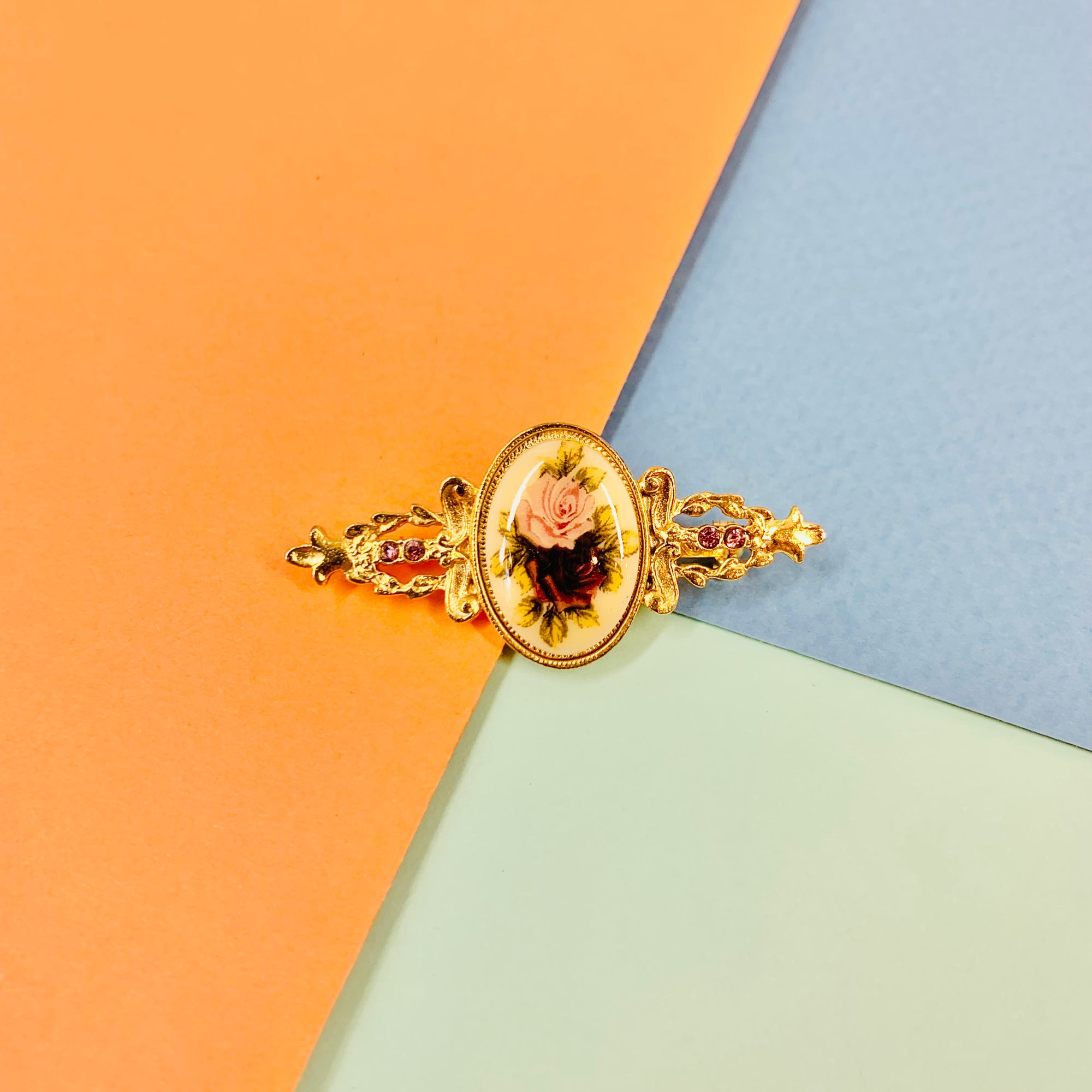 Antique gilt metal costume brooch with floral resin