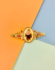 Antique gilt metal costume brooch with floral resin