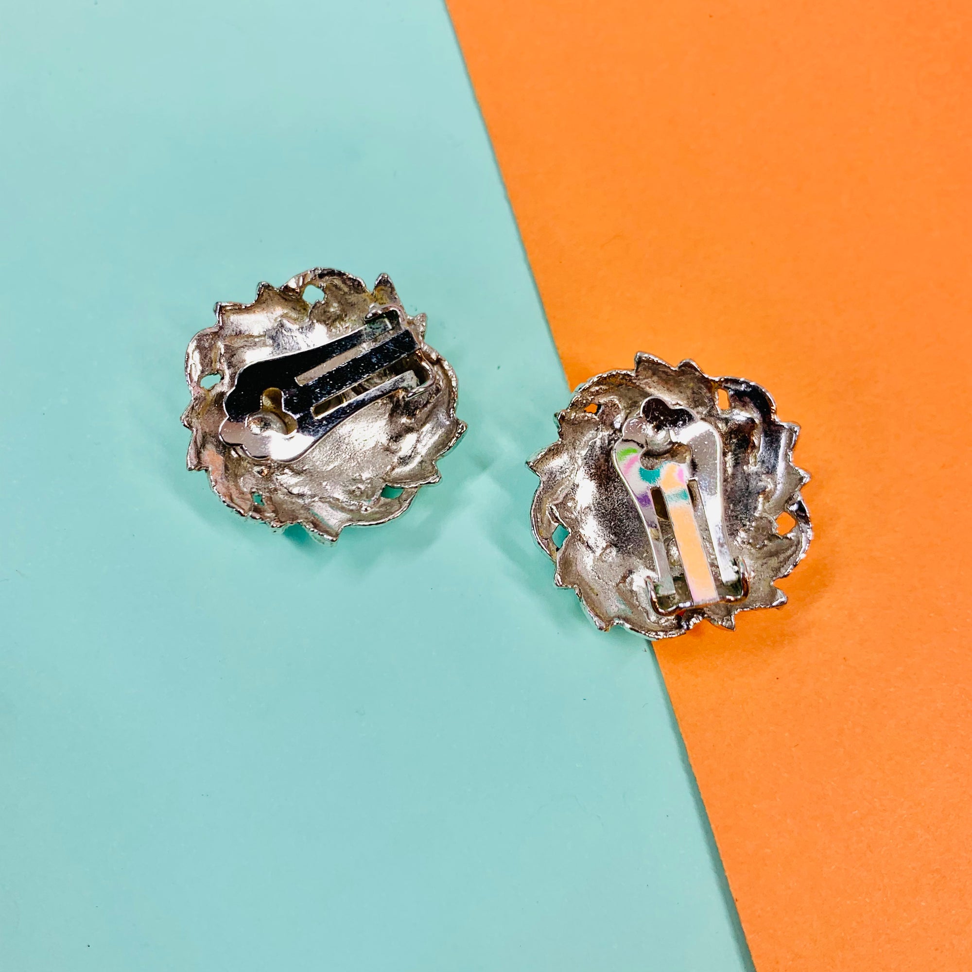 1940s silver nickel clip on earrings with green cats-eye bead