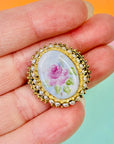 Antique gilt metal brooch with seed pearls and hand painted rose porcelain