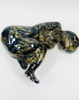 Australian pottery sculpture depicting woman clutching her stomach