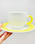 1980s hand painted Italian white porcelain coffee cup and matching saucer with yellow rim