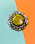 1940s silver nickel brooch with green cats-eye bead