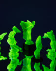 Art Deco reproduction of Lalique Nude with star bangle cape figurine in uranium glass