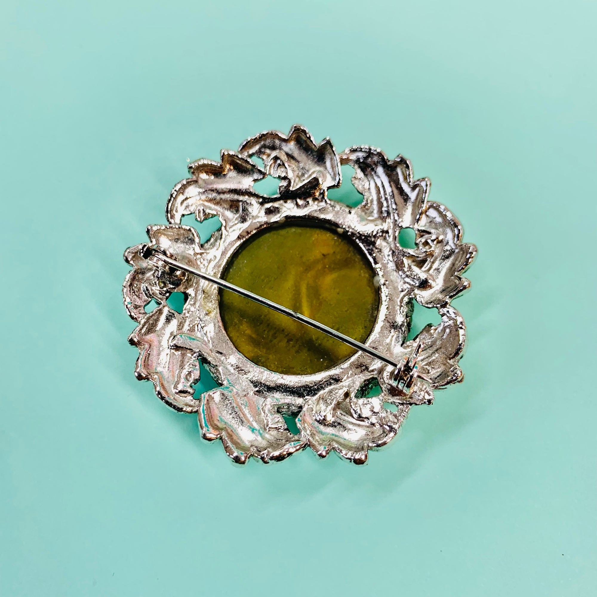 1940s silver nickel brooch with green cats-eye bead