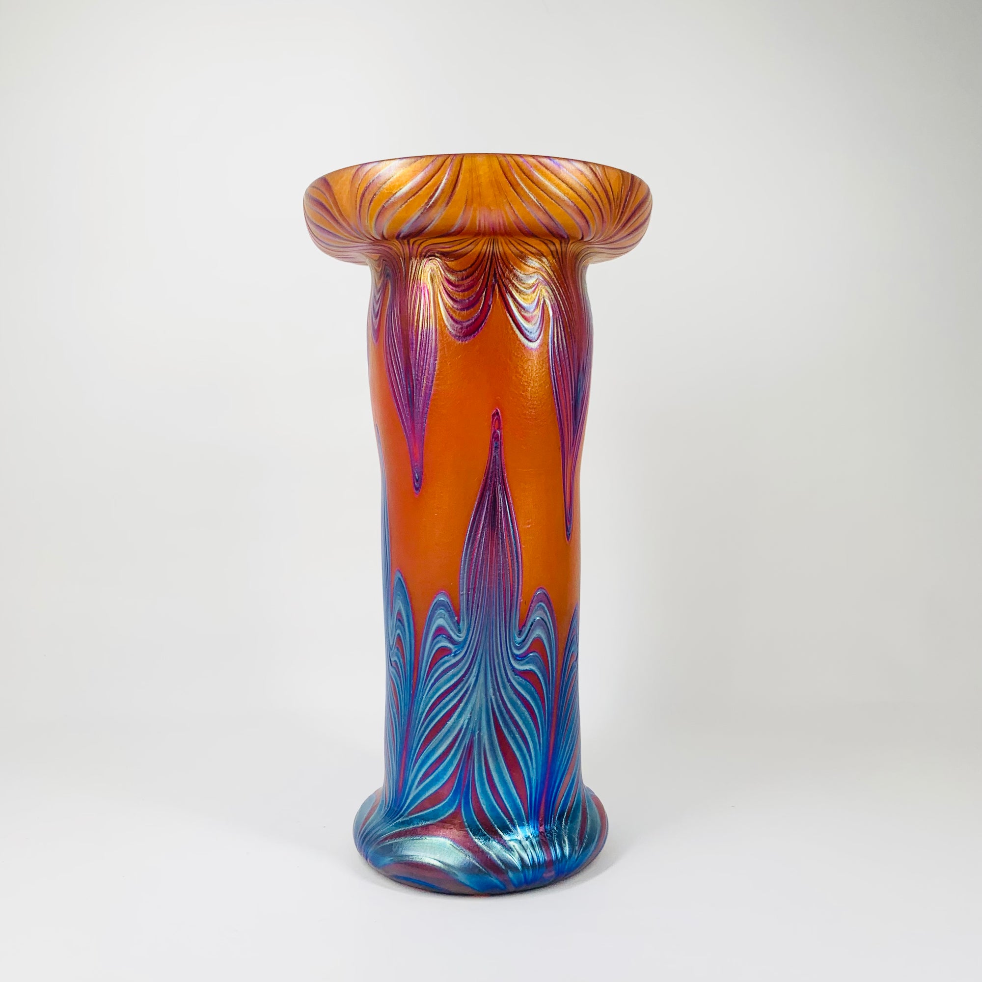Mouth blown peacock orange and blue iridescent Art Nouveau style glass vase