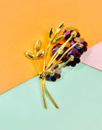 1970s gold plated flower bouquet brooch with iridescent purple Swarovski crystal flowers