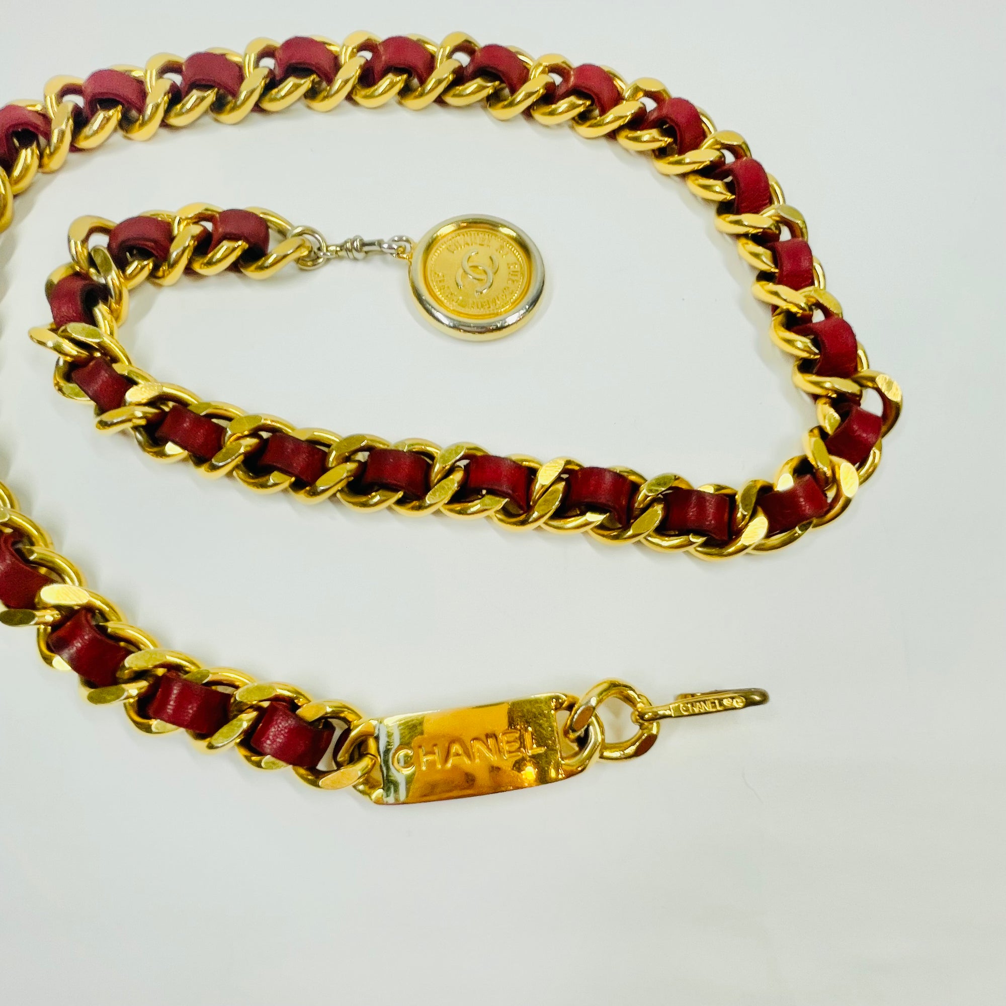1980s CHANEL RED/BURGUNDY LEATHER GOLD PLATED LOGO BELT