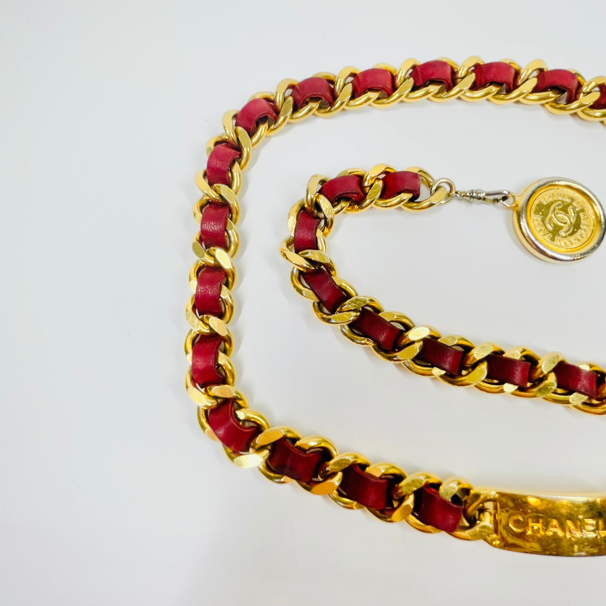 1980s CHANEL RED/BURGUNDY LEATHER GOLD PLATED LOGO BELT