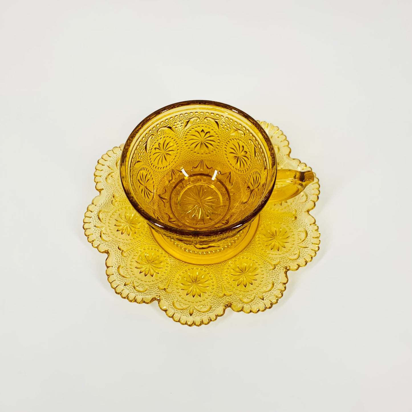 ANTIQUE AMBER PRESSED GLASS TEA CUP & SAUCER