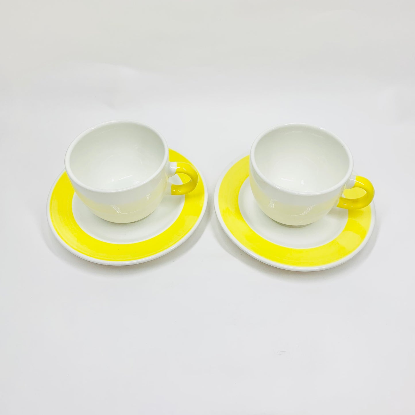 1980s hand painted Italian white porcelain coffee cup and matching saucer with yellow rim
