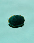 Antique gilt metal costume brooch with green stone
