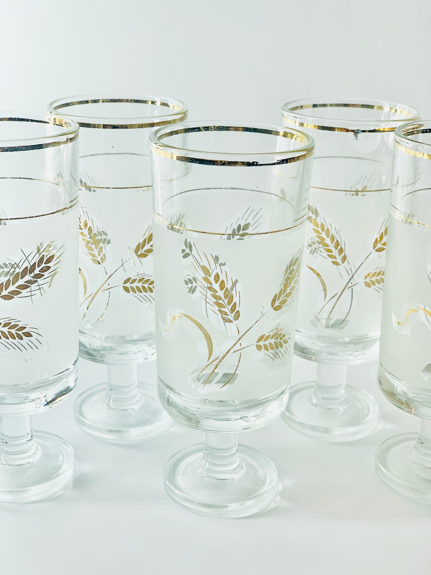 Midcentury laminated gold footed highball glasses