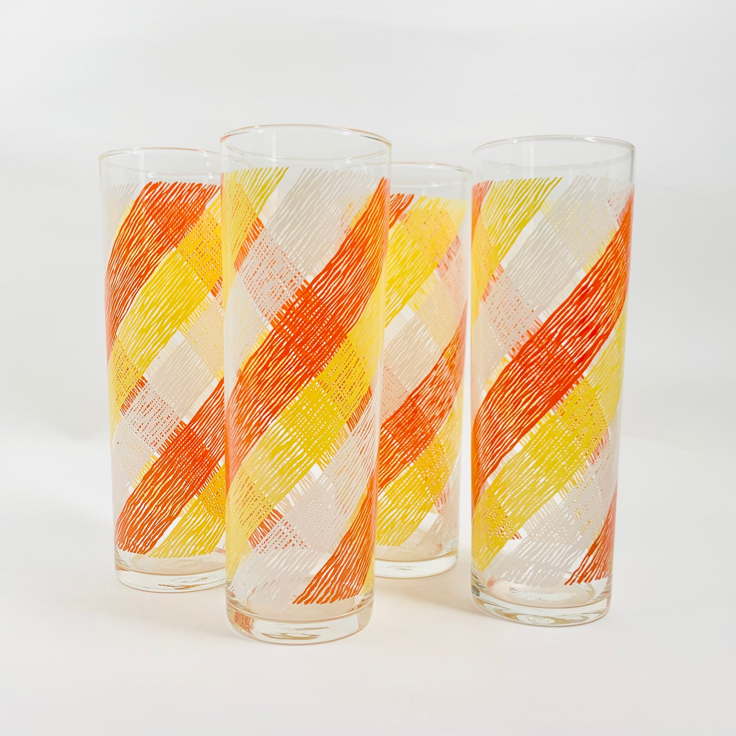Tall 1970s orange laminated waves pattern highball glasses