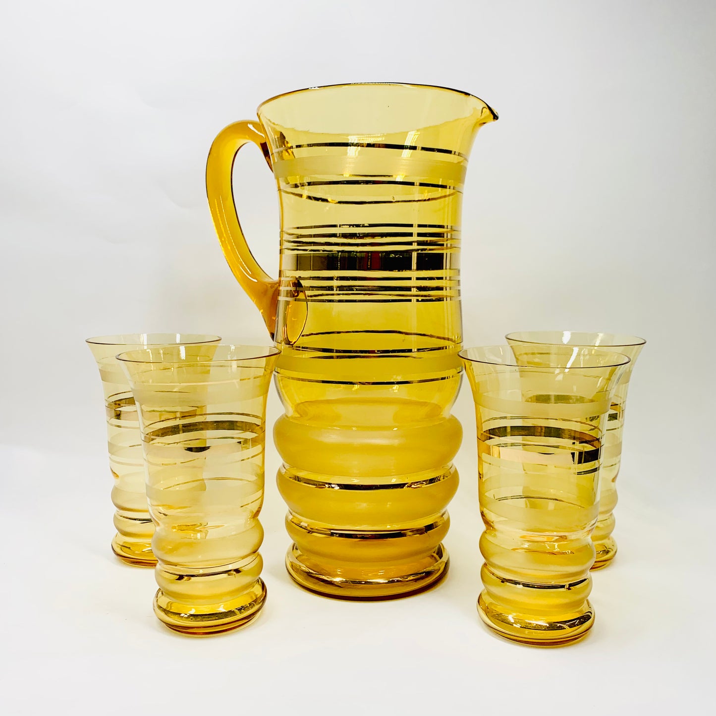 Midcentury gold gilded tall amber glasses and matching water jug/pitcher