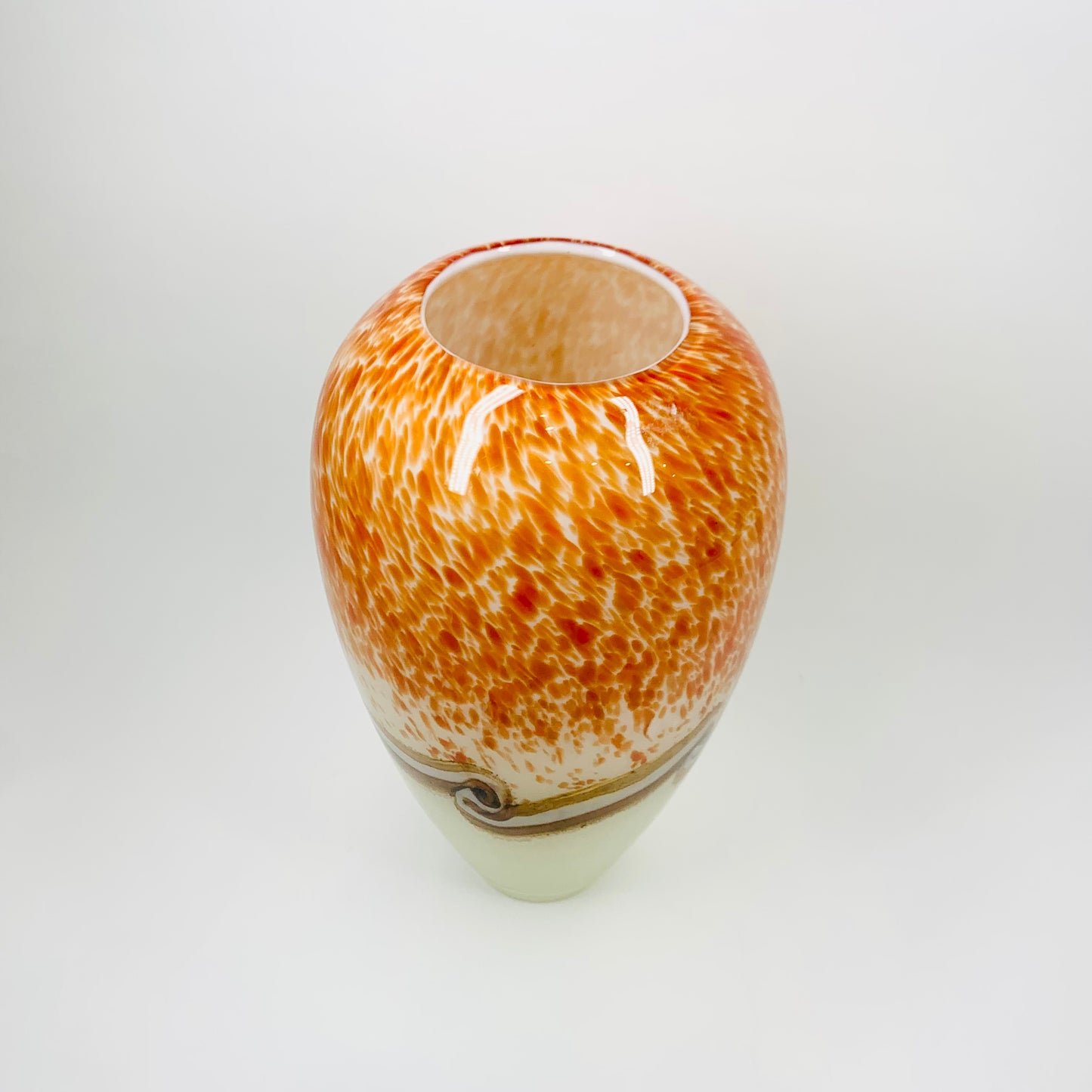 Vintage hand made orange cased art glass vase with abstract pattern