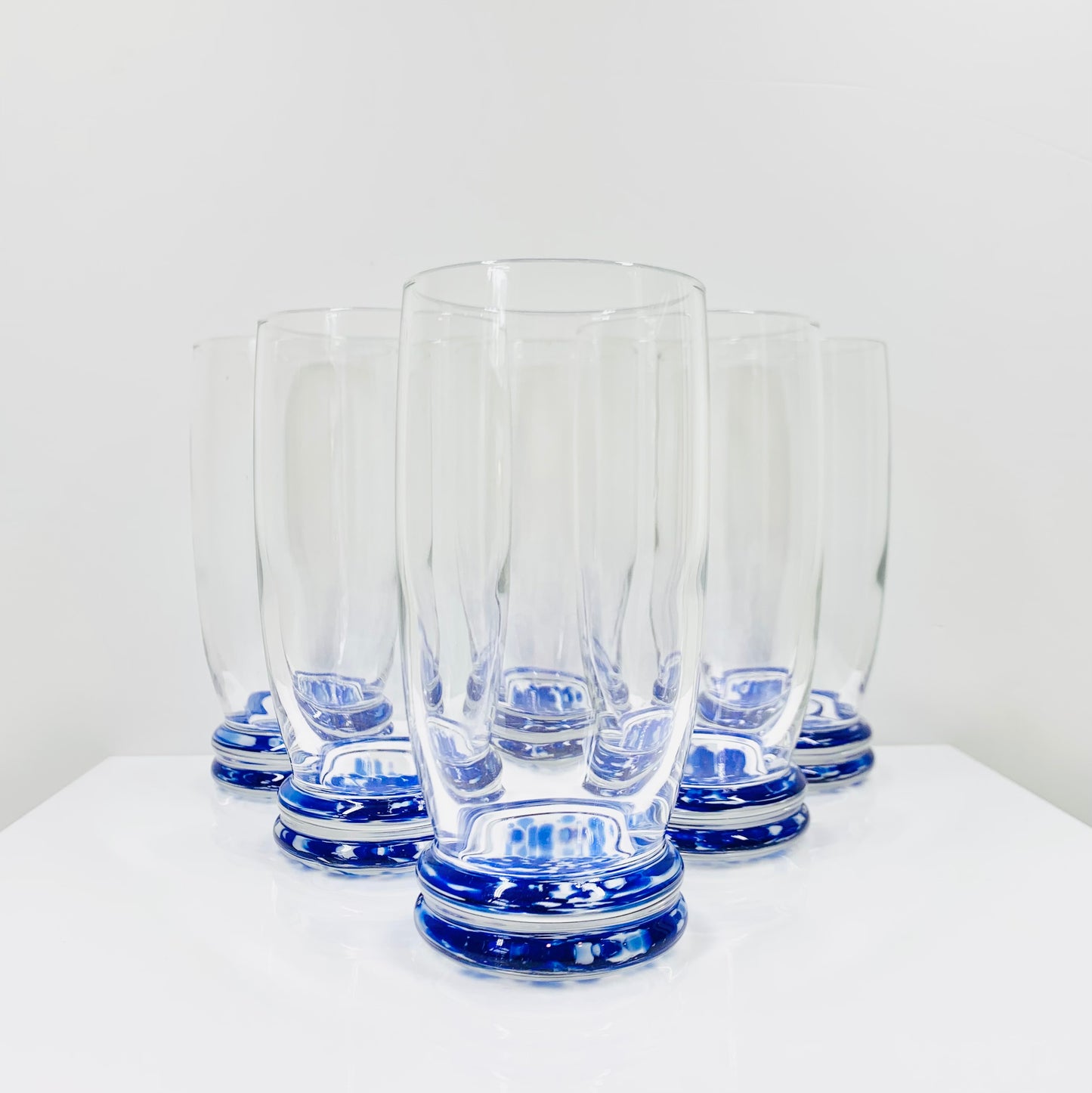 Vintage clear water tumblers with cobalt confetti art glass base