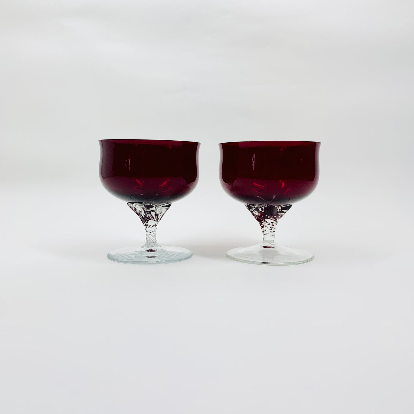 Midcentury red glass coupe with clear twist stem