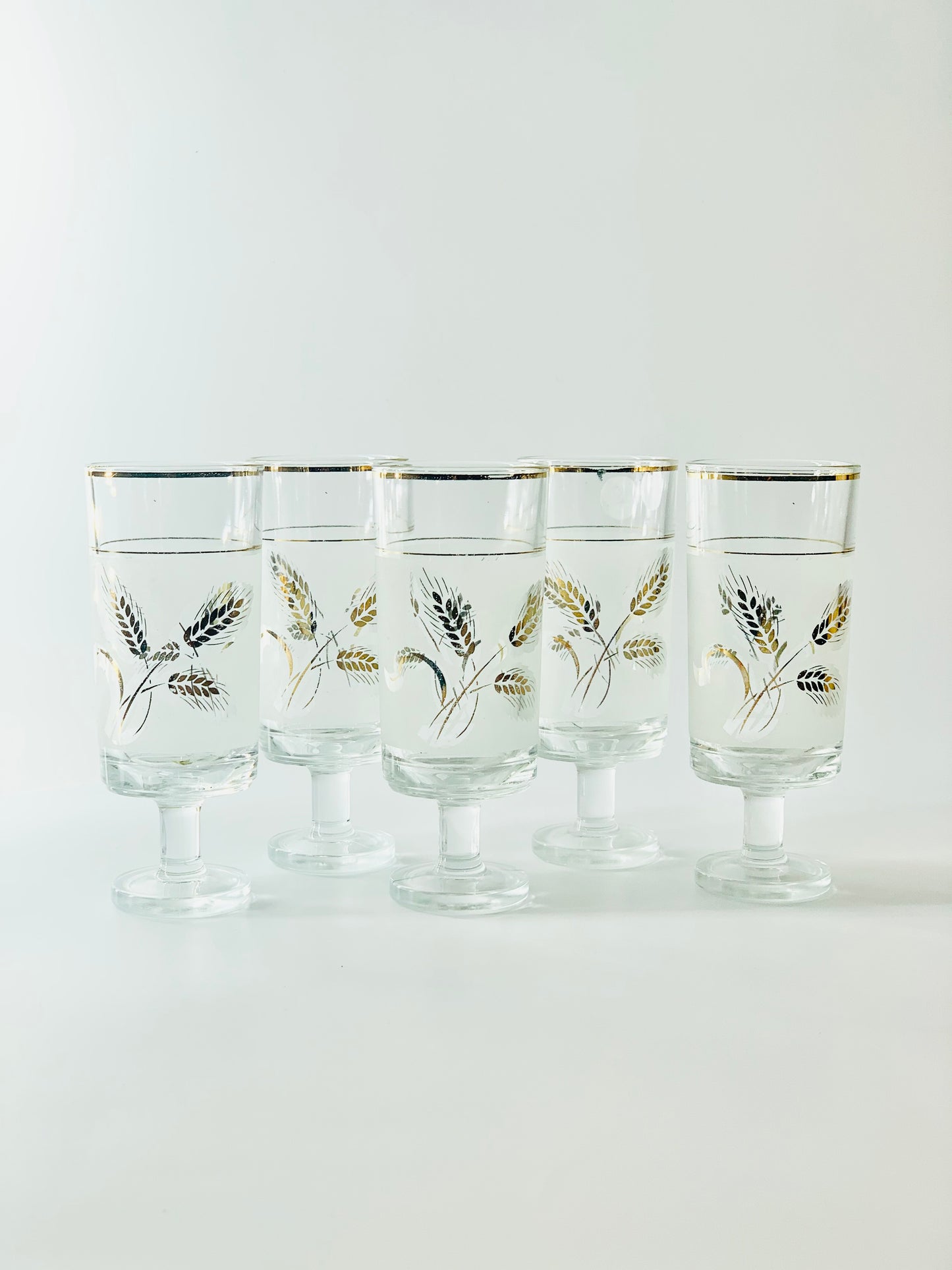 Midcentury laminated gold footed highball glasses