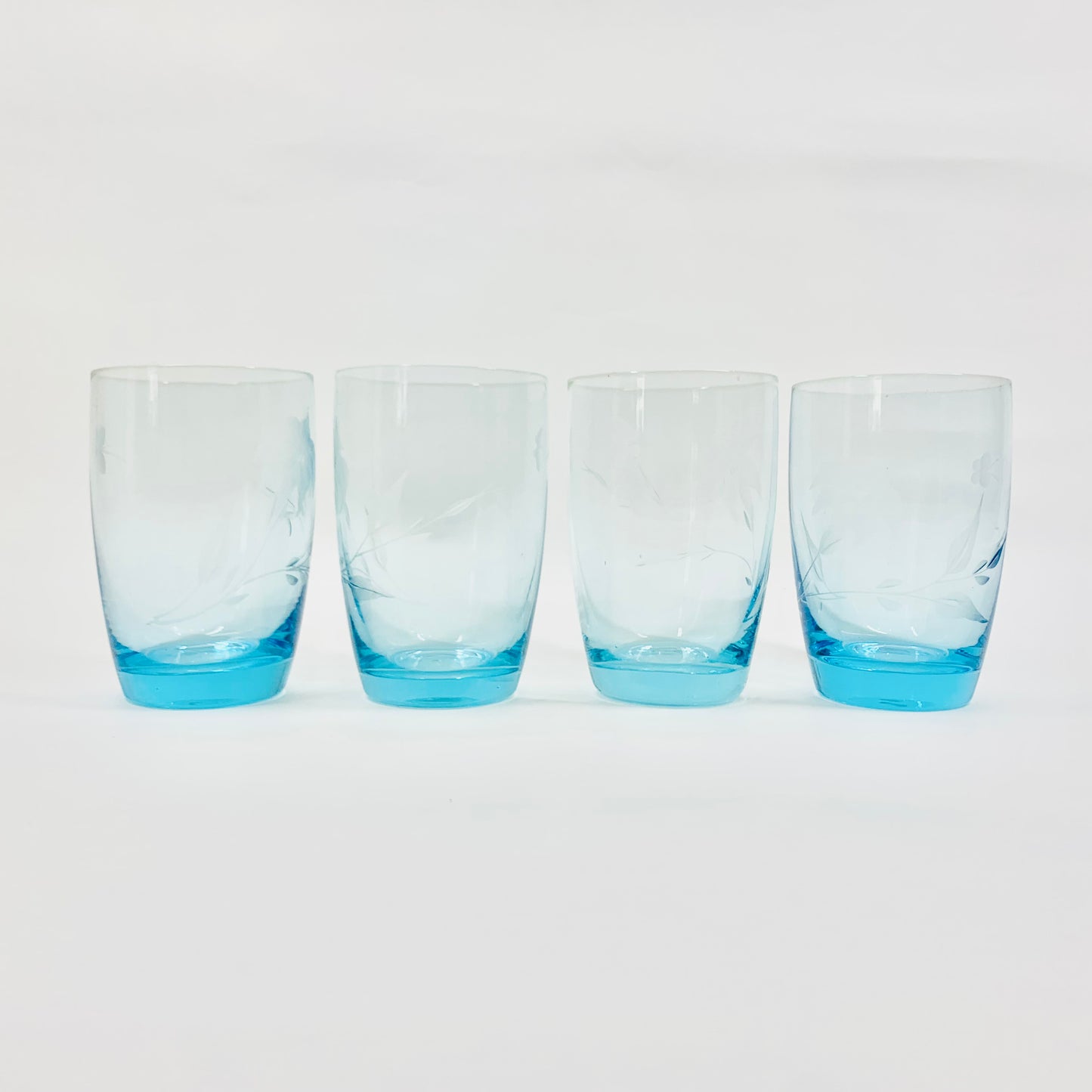 Midcentury turquoise etched glass tumblers with hibiscus pattern