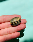 Antique gilt metal costume brooch with green stone