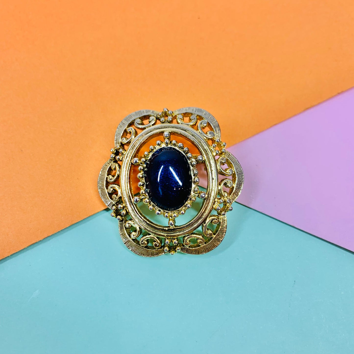 Antique gilt metal costume brooch navy blue resin GLASS ET CETERA