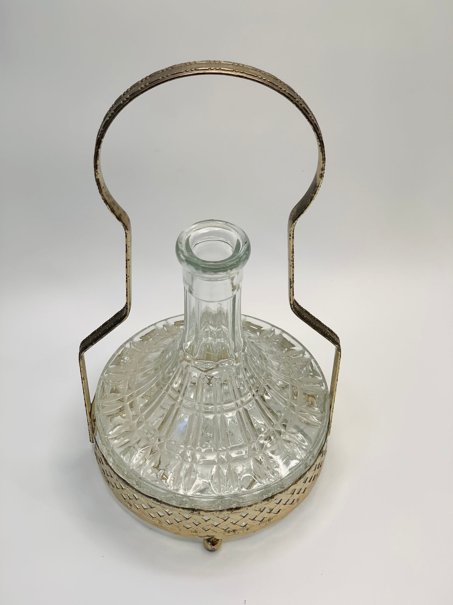 Antique glass decanter with silver plated carrier