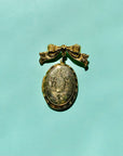 Antique brass bow locket brooch
