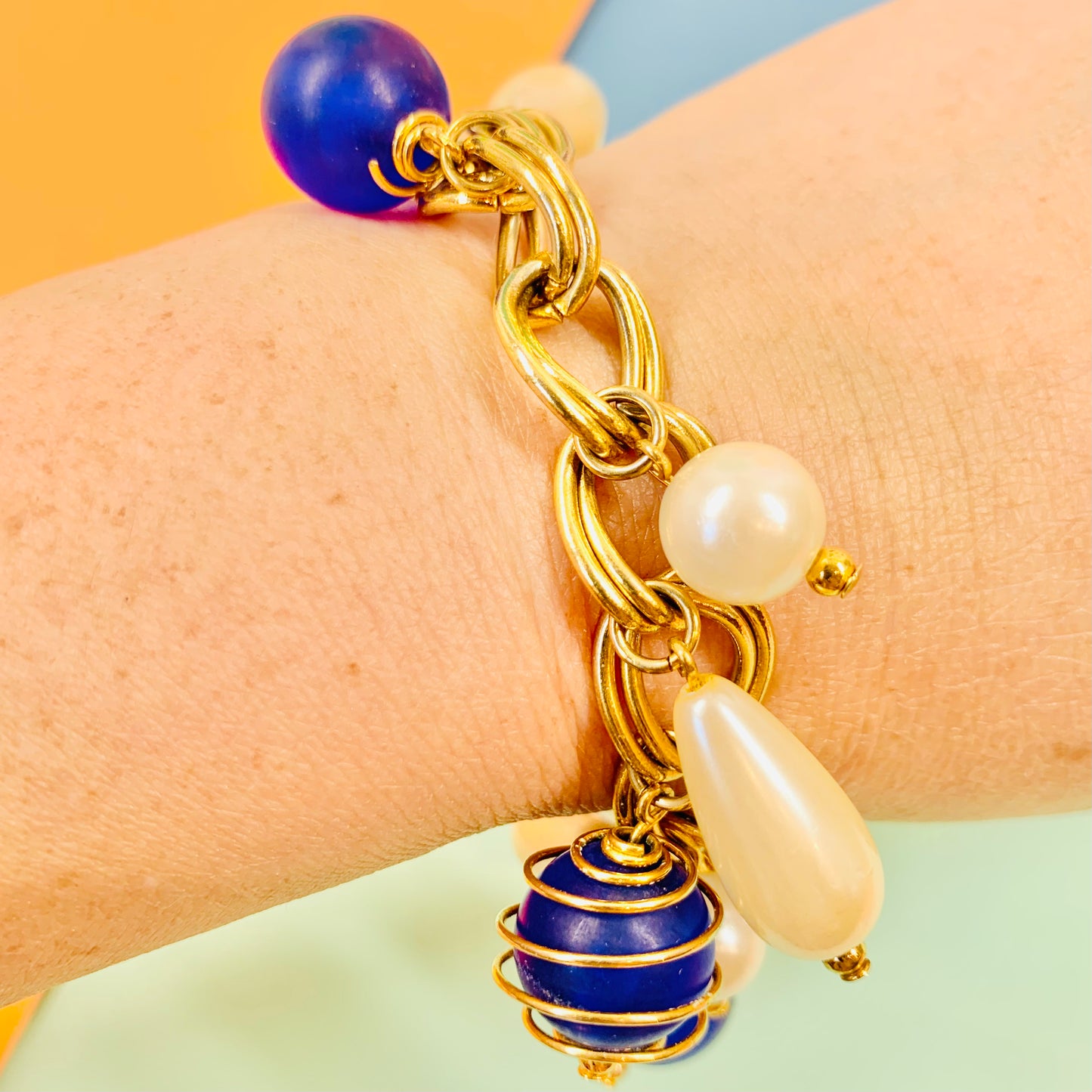 1980s costume gold plated charm bracelet with pearls & blue beads
