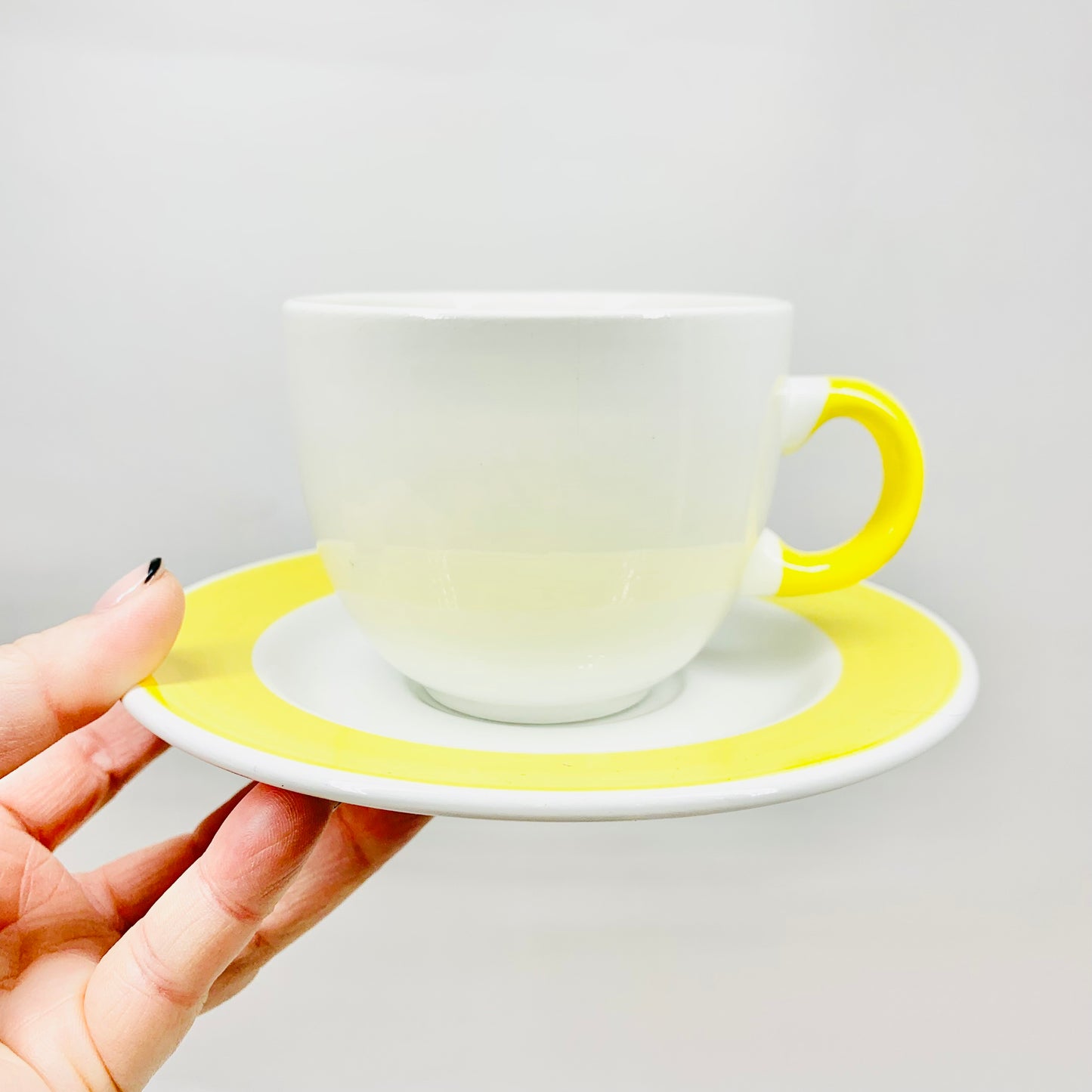1980s hand painted Italian white porcelain coffee cup and matching saucer with yellow rim