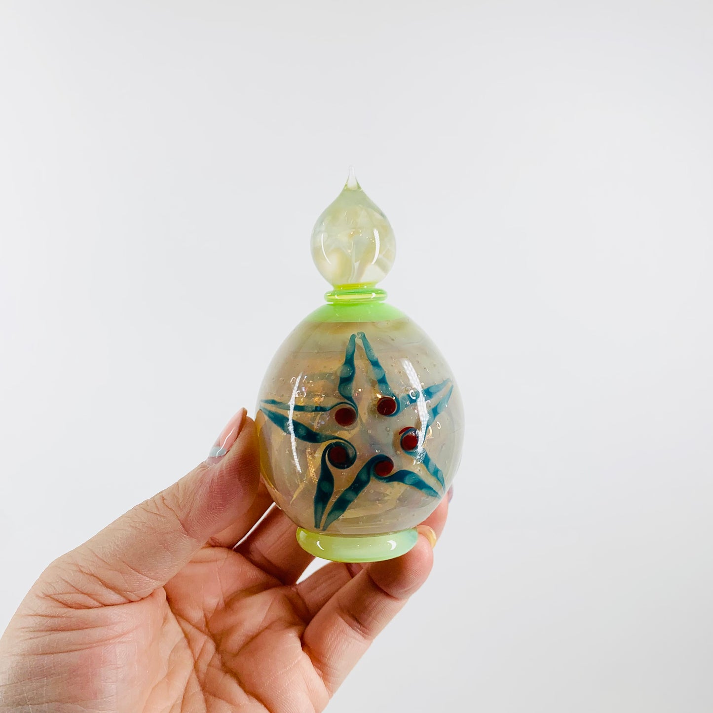 Stunning hand made opalescent glass perfume bottle with star pattern