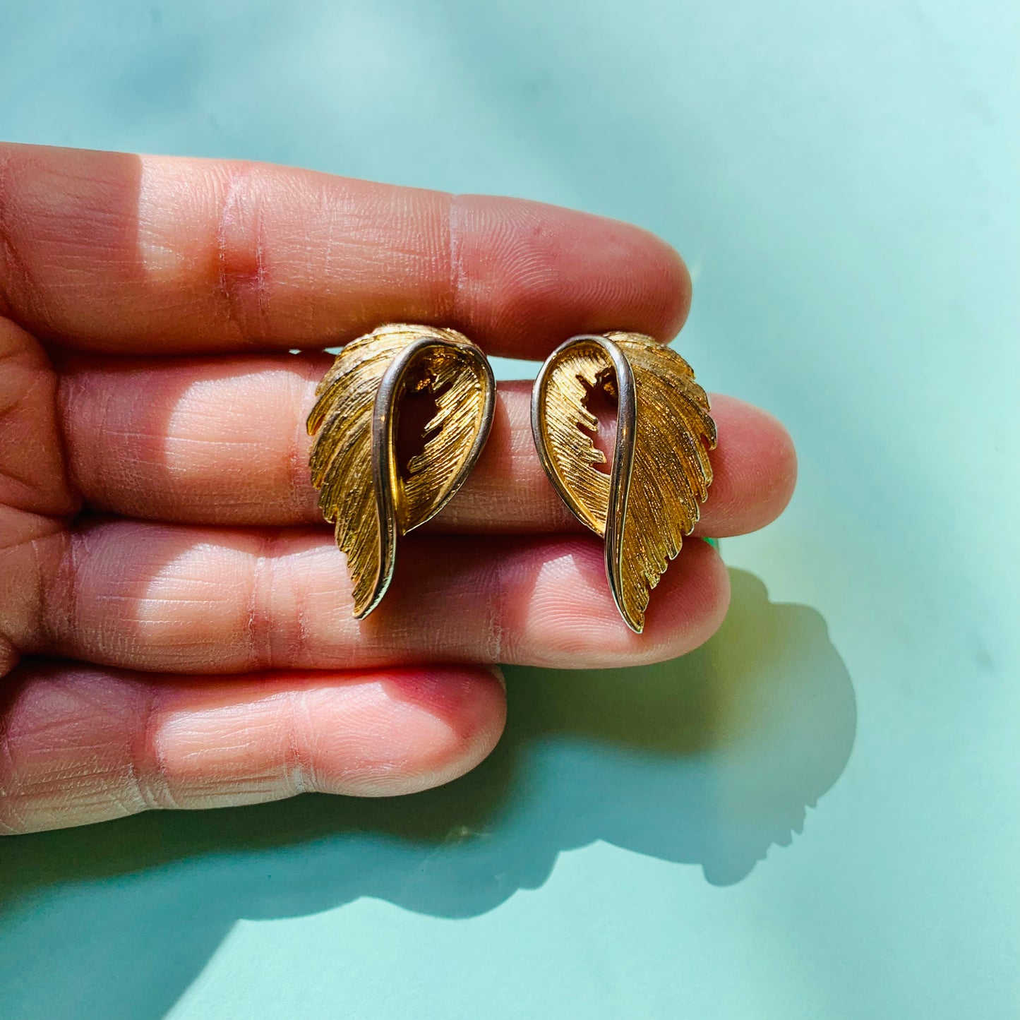 1960s gold plated folded leaf clip on earrings by Monet