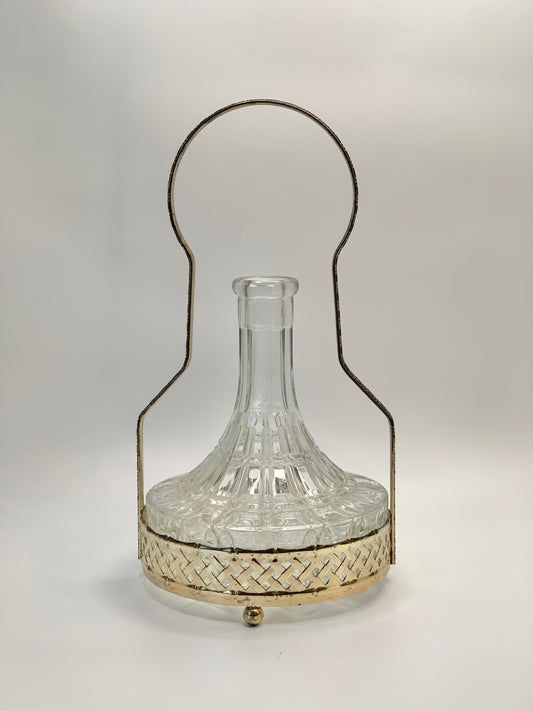 Antique glass decanter with silver plated carrier