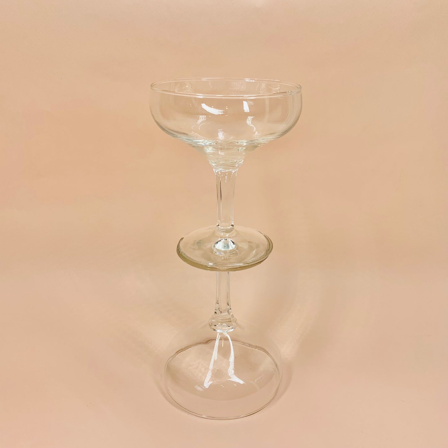 Antique glass champagne coupe with faceted stem