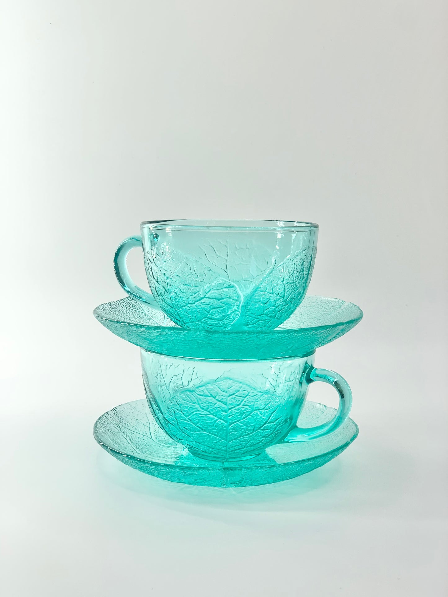 Retro textured leaf pattern teal glass Arcoroc tea cup and saucer