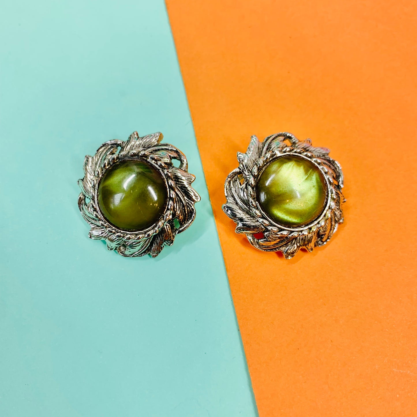 1940s silver nickel clip on earrings with green cats-eye bead